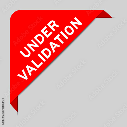 Red color of corner label banner with word under validation on gray background