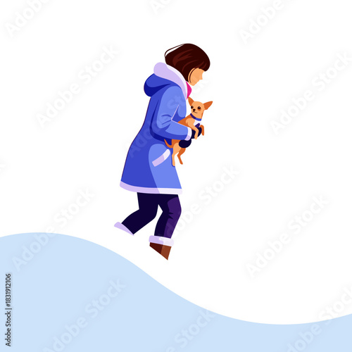 Woman carrying a tiny dog while walking in winter snow  