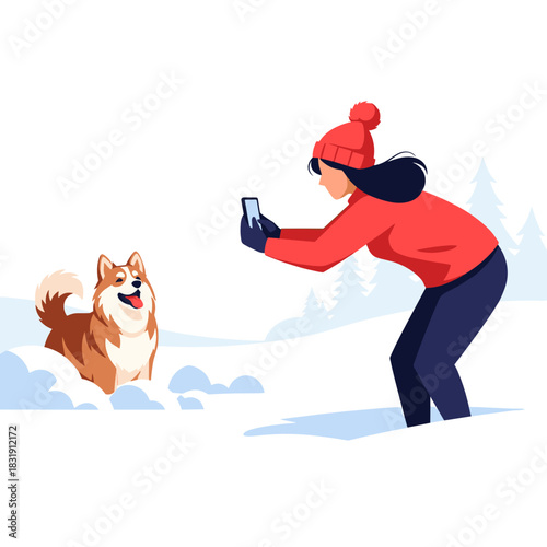 Woman taking photo of dog in snow during winter walk in park  