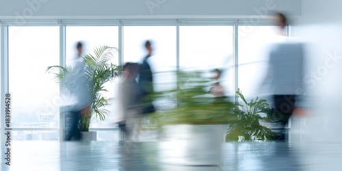 Blurry image of people walking in a room with plants