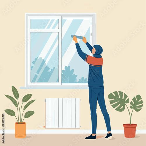 Una persona aplica cinta aislante en la ventana desde el interior para proteger la casa del frío invernal.
