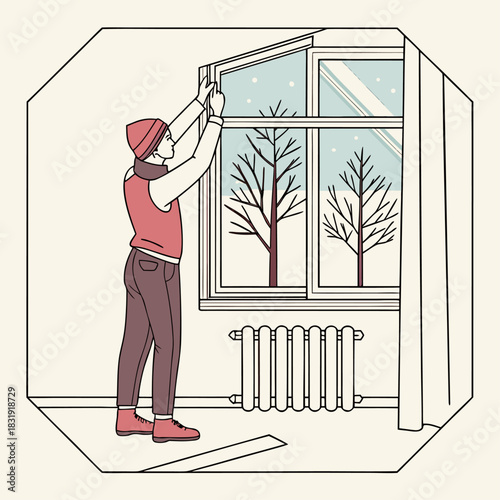 Una persona instala burletes en la ventana de una habitación con vistas a un paisaje nevado. Cerca hay un radiador.
