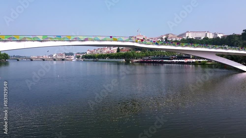 Drone flying under bridge revealing Coimbra and the University of Coimbra
