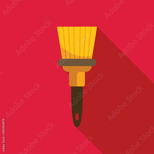 Yellow paint brush casting long shadow on red background, painting tool for creative projects and home renovation
