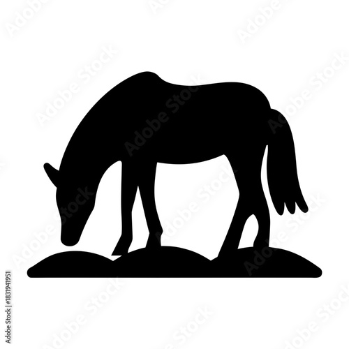 A black horse silhouette grazing in a field silhouette