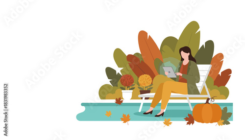 Relaxed woman using tablet outdoors in autumn garden with pumpkin and fall foliage