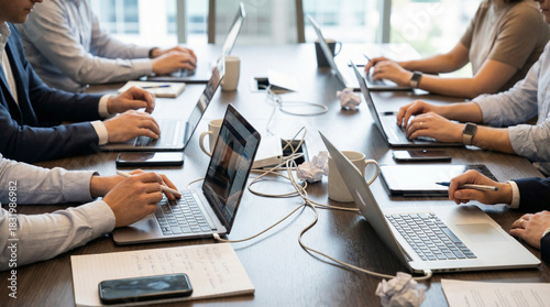 Business professionals working on laptops in a modern office meeting
