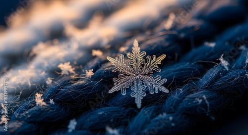 Intricate snowflake rests delicately on a dark blue, woven wool surface, shimmering with frosty light.