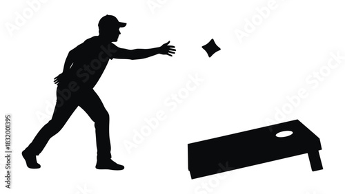 Silhouette of man playing cornhole game outdoor backyard activity