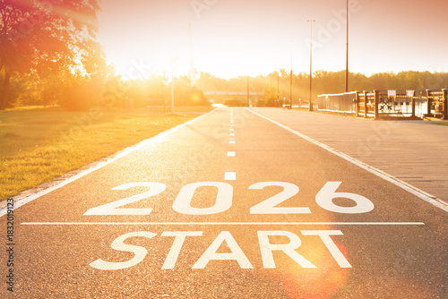 New year 2026 start concept idea. Number of the 2026 year is written on the asphalt on the empty path in sun rays. Concept of planning and vision. A direct path to the future. Motivational background