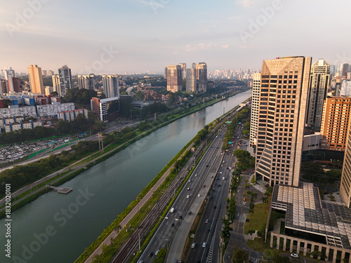aerial view of Pinheiros river in Sao Paulo city with skyline in the distance during sunset