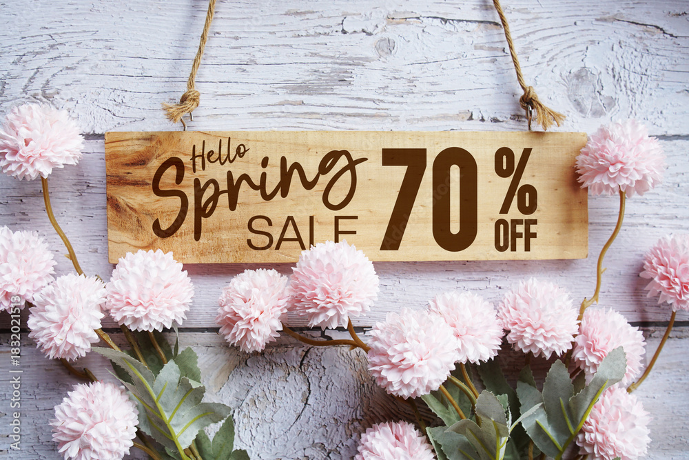 Naklejka premium Spring Sale 70% off with flower bouquet decoration on wooden background