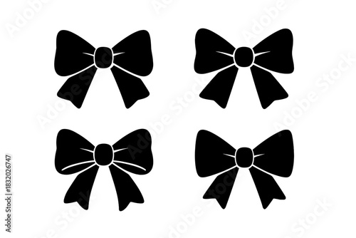 Multiple black ribbon bows displayed in a simple, artistic arrangement on a white background