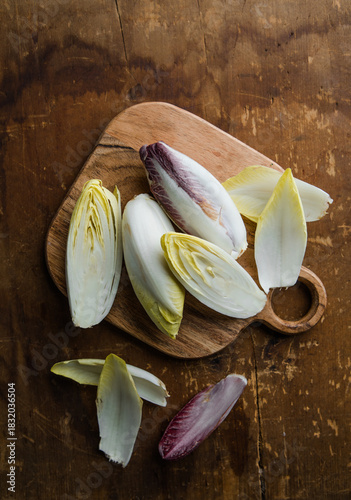 Group of fresh green Belgian endive or chicory and red Radicchio vegetables, also known as witlof salade