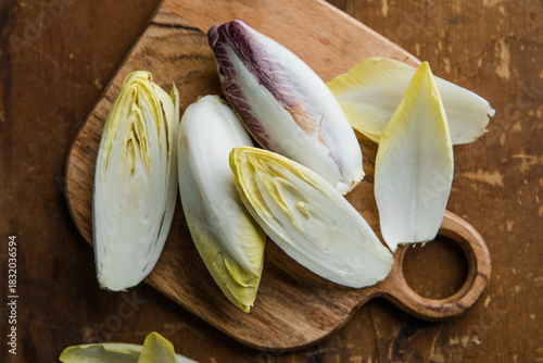 Group of fresh green Belgian endive or chicory and red Radicchio vegetables, also known as witlof salade
