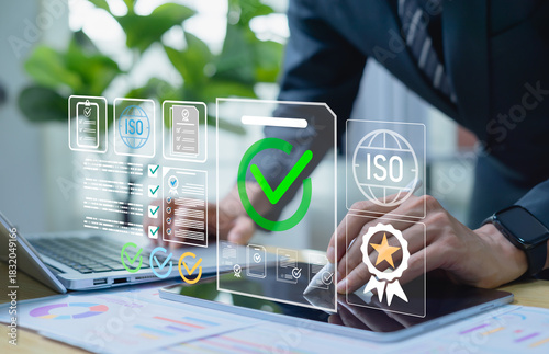 Quality assurance and ISO standards review concept with a professional analyzing digital audit files on a laptop, checking compliance indicators, workflow accuracy, and continuous process optimization