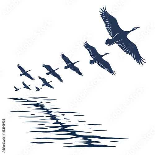 Flock of geese flying in formation over rippling water surface in silhouette