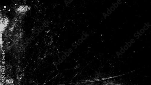 Monochrome grunge texture with scratches and paint splashes creating a dynamic visual backdrop for creative projects.