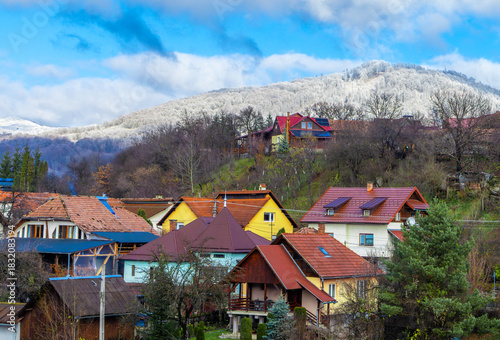Wallpaper Mural Landscape with the houses of a village in a mountainous area in late autumn and in the background a mountain with snow on the forest. Two seasons, the transition from autumn to winter Torontodigital.ca