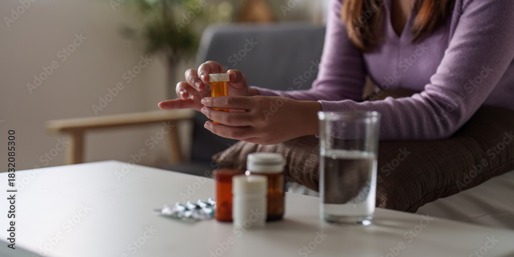 Obraz premium Medication Management. Woman holding prescription bottle, contemplating health.