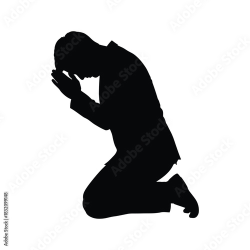 Silhouette of a man in a suit kneeling with hands clasped in prayer or supplication