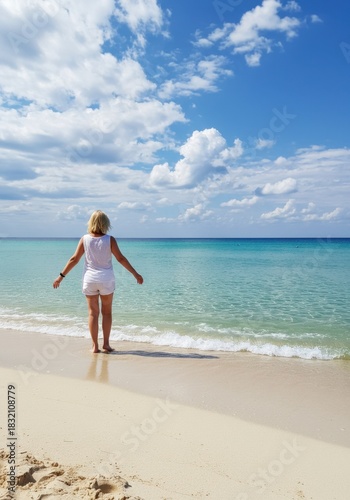Woman in White on a Sandy Beach Gazing at the Turquoise Ocean