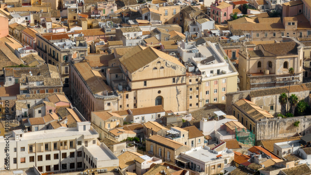Fototapeta premium Aerial view of houses, roofs, and buildings in Ortygia. This is the historic center of Syracuse, Sicily, Italy. 