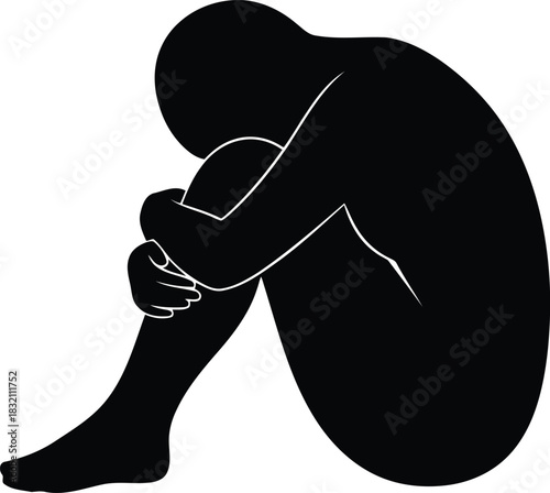 Silhouette of person curled up in despair