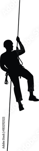 Silhouette of person rappelling down rope