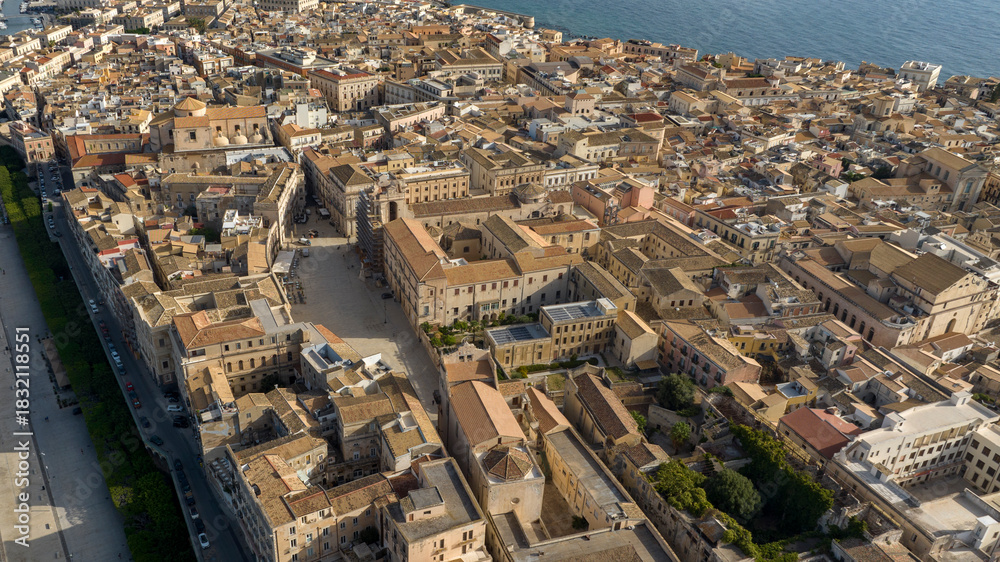 Fototapeta premium Aerial view of the island of Ortygia. This is the historic center of Syracuse, Sicily, Italy. The city overlooks the Mediterranean Sea and contains many historical landmarks. It's a summer morning.