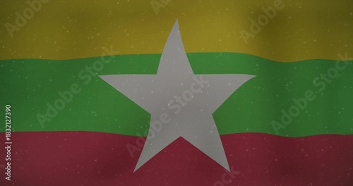 Displaying Myanmar flag, full-frame, yellow green red bands, white star, distressed overlay