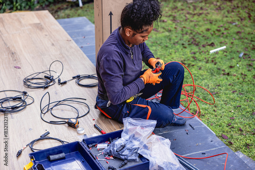 Woman electrician preparing solar panel wiring connections