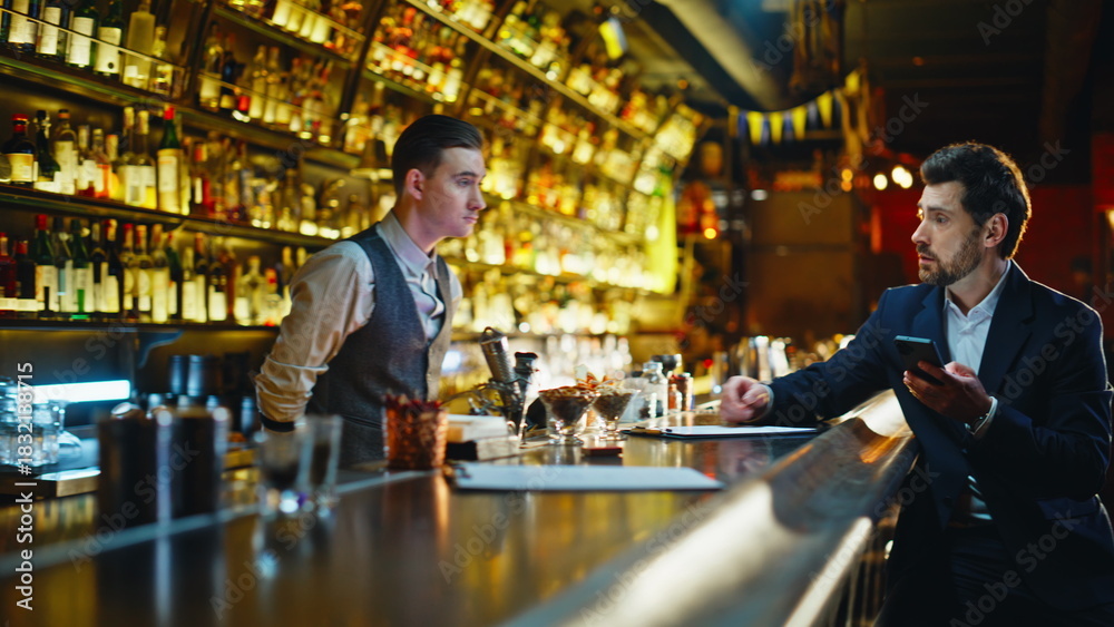 © stockbusters - Waiter working bar counter.Businessman coming cafe ordering drink in evening © stockbusters - Waiter working bar counter.Businessman coming cafe ordering drink in evening