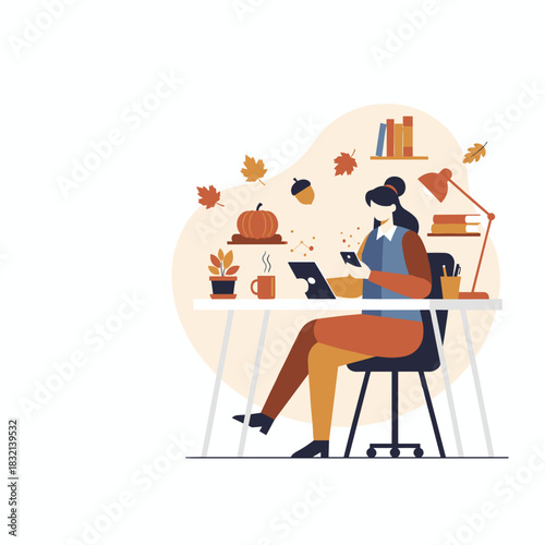 Professional woman works remotely during autumn using devices at a cozy desk with fall decor