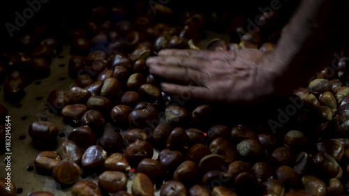 Wallpaper Mural Close-up shot of ripe chestnuts frying in a pan, hand-mixed by a man. Fresh chestnut nuts used in traditional cooking Torontodigital.ca