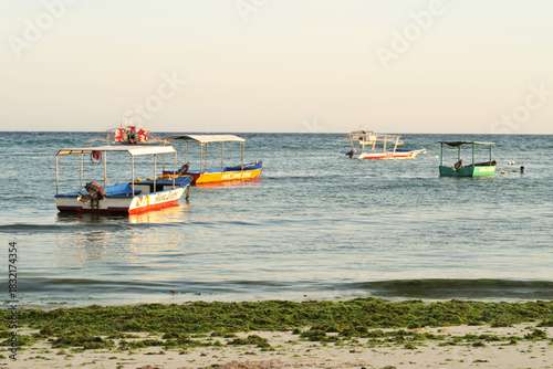 Small motorboats, fishing boats at Alona Beach at golden hour, Panglao Island, Bohol Island, Philippines