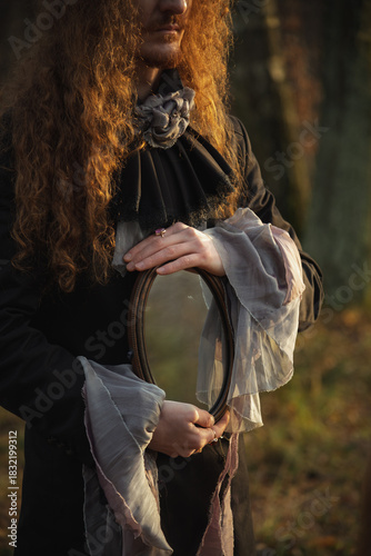Reflective moment in a forest setting with a figure holding a mirror