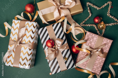 Festive Christmas new year 2026  background with  elegant wrapped gifts and golden decorations on a green background, joyful atmosphere for special occasions