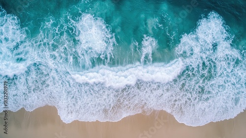 High-definition overhead shot of foam-tipped waves embracing shallow turquoise waters