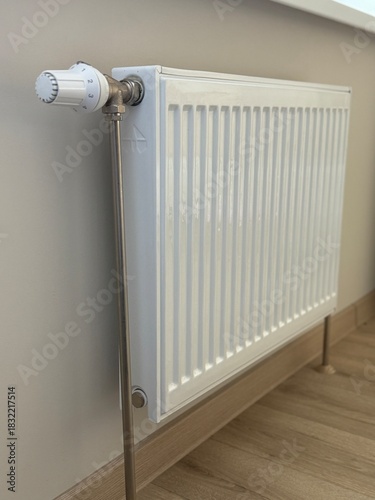 Wallpaper Mural White steel radiator on the background of a beige wall.
The heating level is regulated by a handle.
The option of heating a house, apartment, institutions. Torontodigital.ca