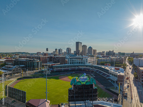 Dayton, United States - 08 September 2025: Aerial view of the baseball field basks in the sun, framed by the city skyline's muted tones and the vibrant green of the field.