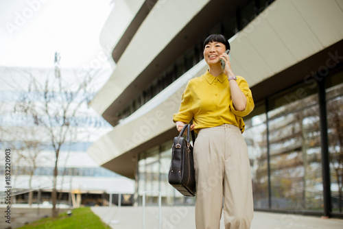 Woman in yellow shirt walks...