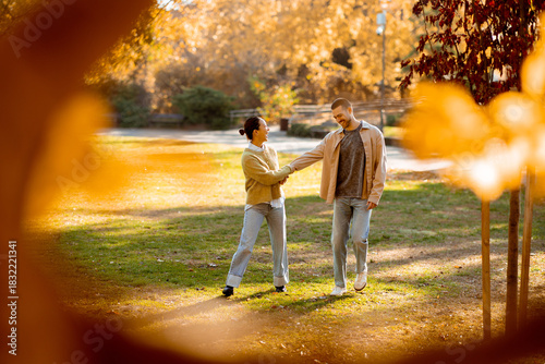 Cuadro en lienzo Autumn walk in the park with a Korean woman and Caucasian man amidst colorful le