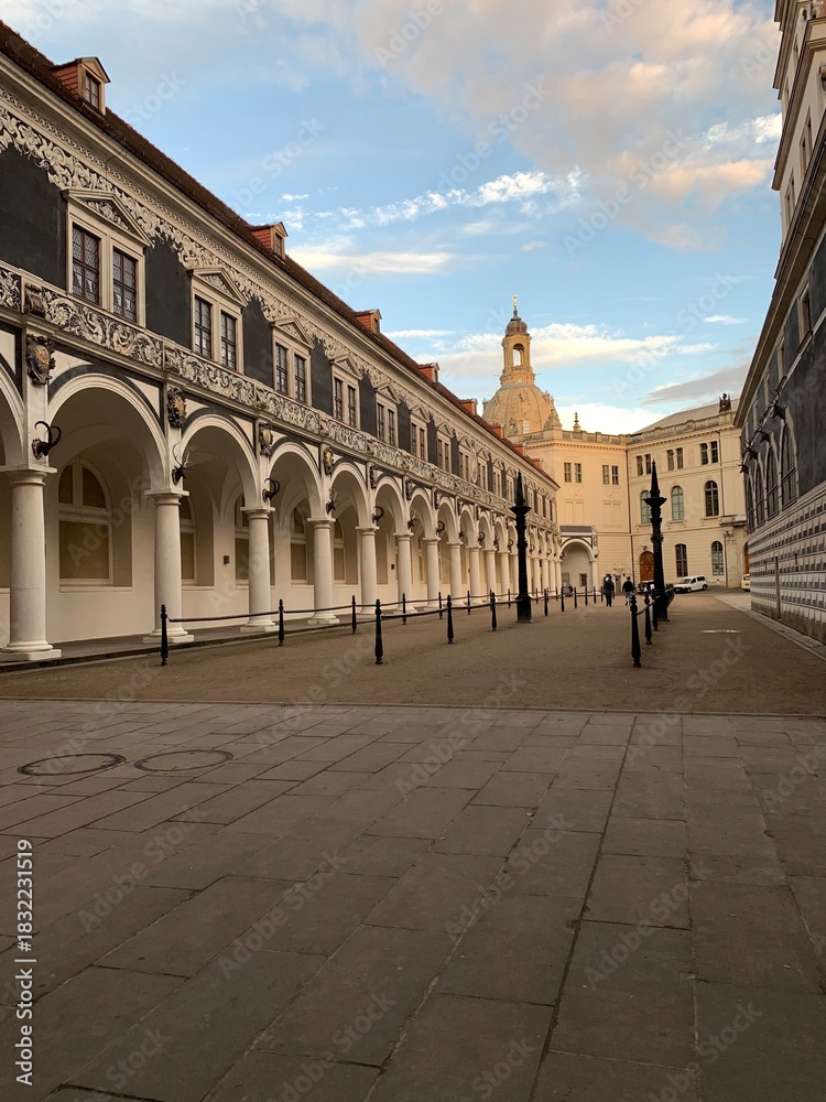 Fototapeta premium Historic European courtyard with classical arches and long shaded walkway