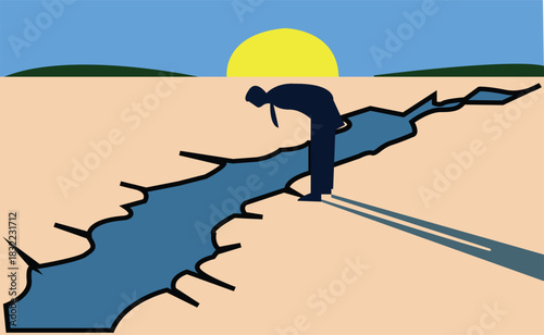 Man standing near crack looking down during day with sun in background