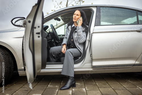 Middle-aged woman sitting in a parked car, holding her phone to her ear and having a conversation after parking.

50 keywords (single words, se