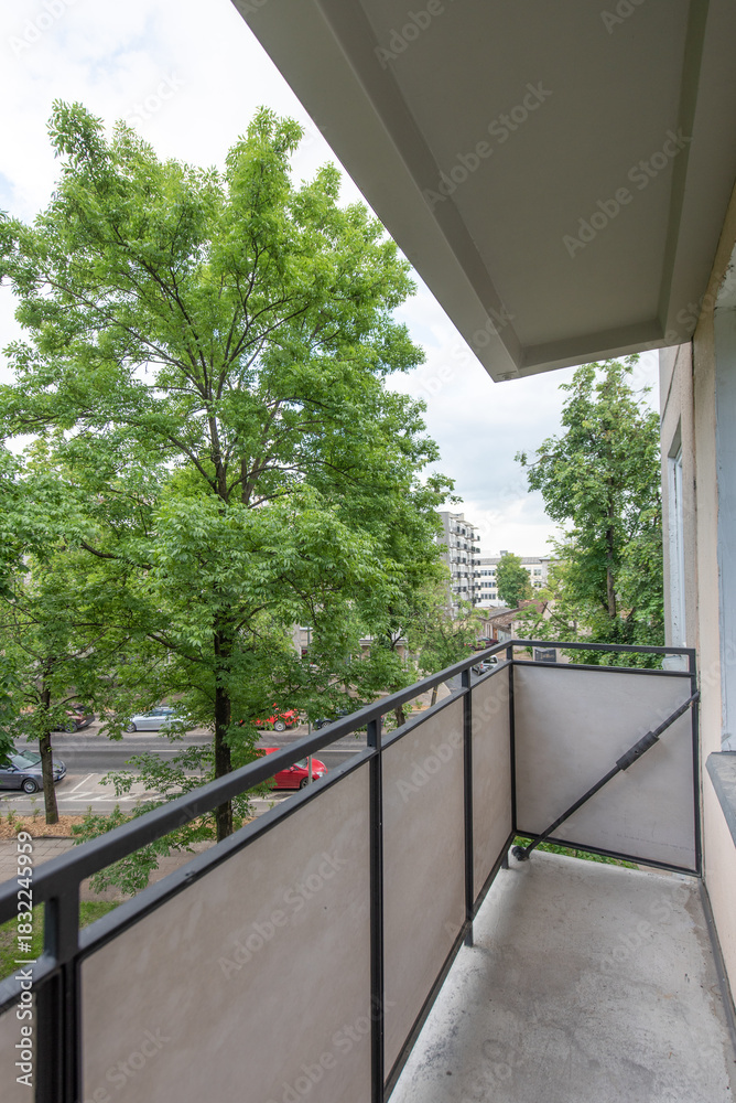 Obraz premium View From Balcony Overlooking Green Trees and Residential Area