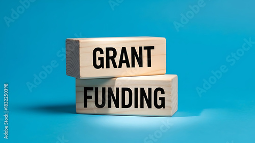 Wooden blocks stacked showing grant funding words