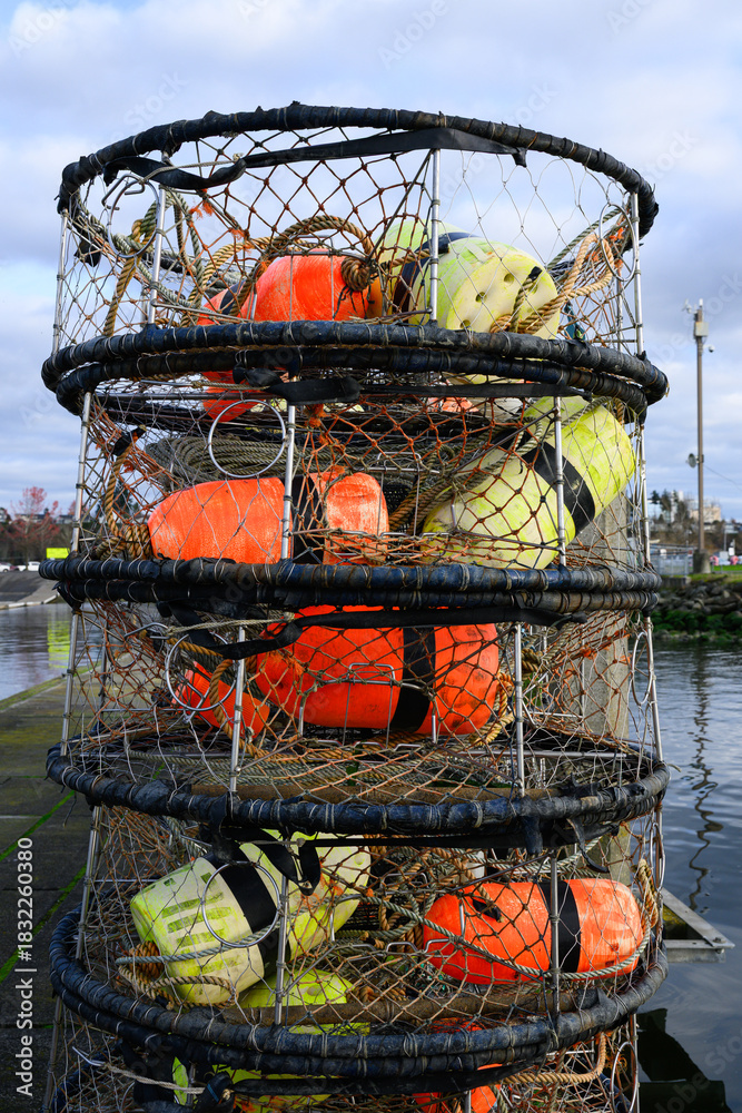 Fototapeta premium Pile of fishing crab pots with colored floats on pier stacked vertically