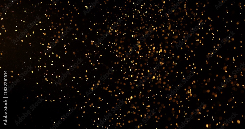 Naklejka premium Abstract particles of gold dust float in the air